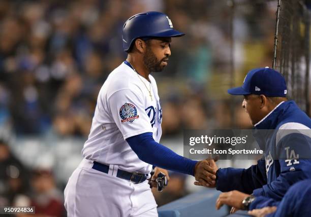 Los Angeles Dodgers Outfield Matt Kemp is congratulated by manager Dave Roberts after being batted in for a run during a Major League Baseball game...