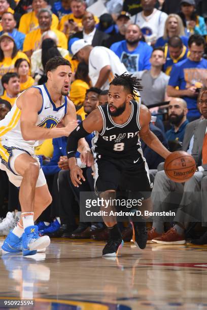 Patty Mills of the San Antonio Spurs handles the ball against the Golden State Warriors in Game Five of Round One of the 2018 NBA Playoffs on April...