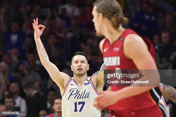 Redick of the Philadelphia 76ers celebrates a three point shot behind Kelly Olynyk of the Miami Heat at Wells Fargo Center on April 24, 2018 in...