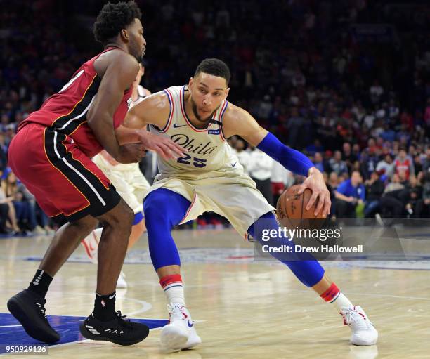 Ben Simmons of the Philadelphia 76ers drives on Justise Winslow of the Miami Heat at Wells Fargo Center on April 24, 2018 in Philadelphia,...