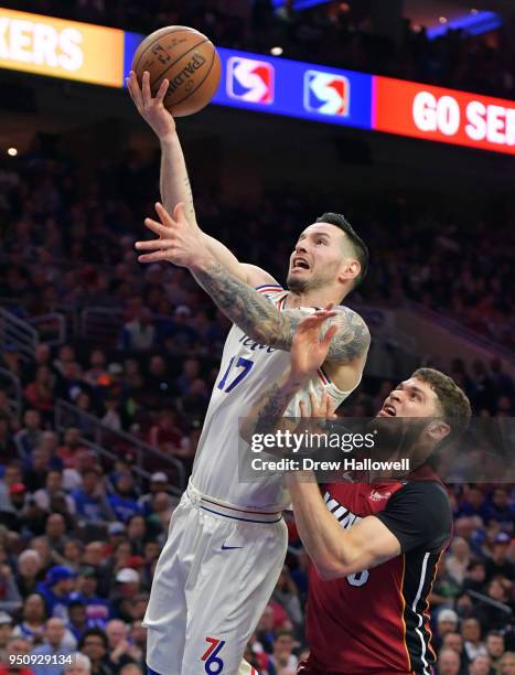 Redick of the Philadelphia 76ers lays up a shot past Tyler Johnson of the Miami Heat at Wells Fargo Center on April 24, 2018 in Philadelphia,...