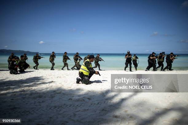 Policemen take part in a security measures exercise on the Philippine island of Boracay island on April 25, 2018. Police with assault rifles...