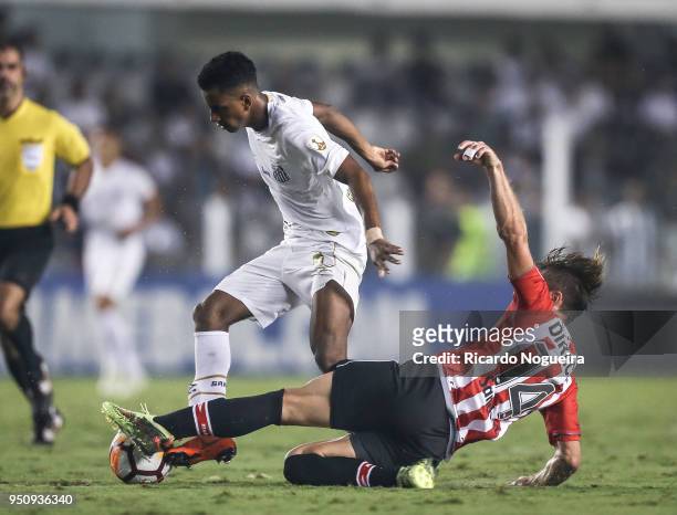 Rodrygo of Santos battles for the ball with Sanchez during the match between Santos and Estudiantes as a part of Copa Libertadores 2018 at Vila...
