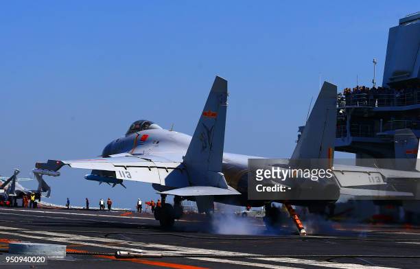 This photo taken on April 24, 2018 shows a J15 fighter jet landing on China's sole operational aircraft carrier, the Liaoning, during a drill at sea....