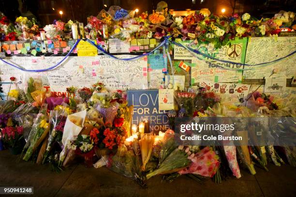 Flowers, cards, and words of sympathy adorn a makeshift memorial for victims of the mass killing on April 24, 2018 in Toronto, Canada. A suspect...