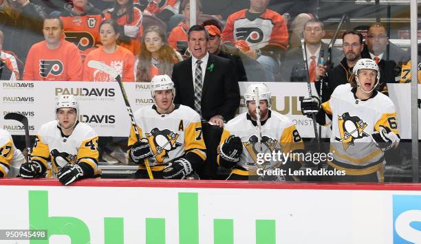 Head Coach of the Pittsburgh Penguins Mike Sullivan reacts to the play on the ice during the first period behind Conor Sheary, Evgeni Malkin, Phil...