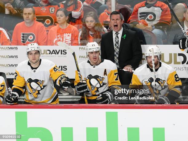 Head Coach of the Pittsburgh Penguins Mike Sullivan reacts to the play on the ice during the first period behind Conor Sheary, Evgeni Malkin and Phil...