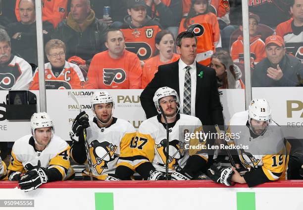 Head Coach of the Pittsburgh Penguins Mike Sullivan looks on during the first period behind Conor Sheary, Dominik Simon, Sidney Crosby and Derick...