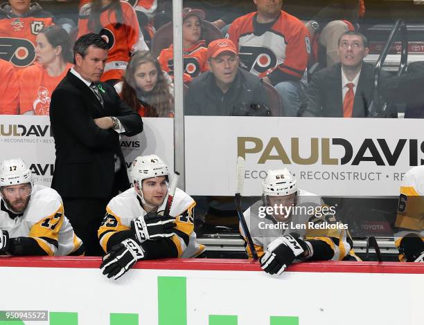 Head Coach of the Pittsburgh Penguins Mike Sullivan looks on during the first period behind Bryan Rust, Conor Sheary and Carl Hagelin against the...