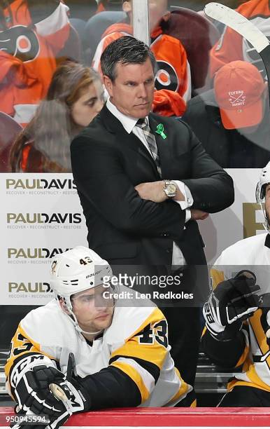 Head Coach of the Pittsburgh Penguins Mike Sullivan looks on during the first period behind Conor Sheary against the Philadelphia Flyers in Game Four...