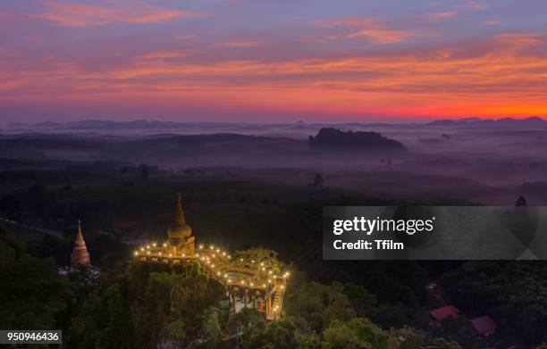 high view of khao na nai luang temple with the colorful sky in the morning at surat thani province, southern of thailand - surat thani province stock-fotos und bilder