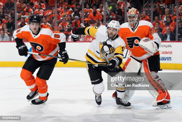 Travis Sanheim and Michal Neuvirth of the Philadelphia Flyers battle against Bryan Rust of the Pittsburgh Penguins in Game Four of the Eastern...