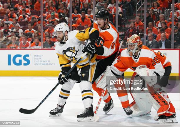 Travis Sanheim and Michal Neuvirth of the Philadelphia Flyers battle against Bryan Rust of the Pittsburgh Penguins in Game Four of the Eastern...