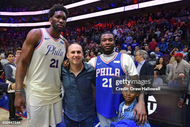 Joel Embiid of the Philadelphia 76ers, co-owner Michael Rubin, Meek Mill and his son Papi pose for a photograph after the game against the Miami Heat...