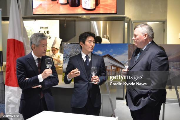 Hiroshi Sakurai and son Kazuhiro , the chairman and president of Asahi Shuzo Co., respectively, speak with Culinary Institute of America President...