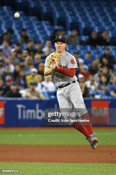 Boston Red Sox Third base Rafael Devers throws over to first base during the regular season MLB game between the Boston Red Sox and Toronto Blue Jays...