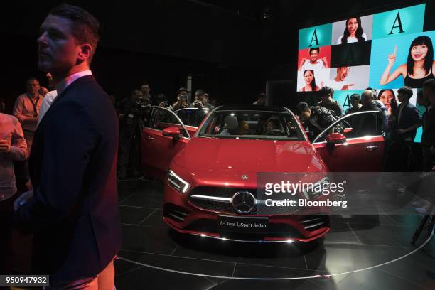 Attendees gather around a new Mercedes-Benz A-Class sedan during a premiere event in Beijing, China, on Tuesday, April 24, 2018. In the past couple...