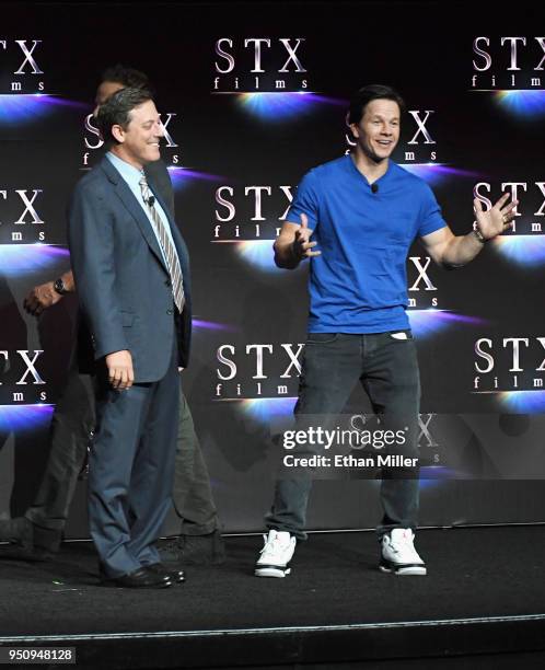 STXfilms Chairman Adam Fogelson and actor Mark Wahlberg speak onstage during the STXfilms presentation at The Colosseum at Caesars Palace during...