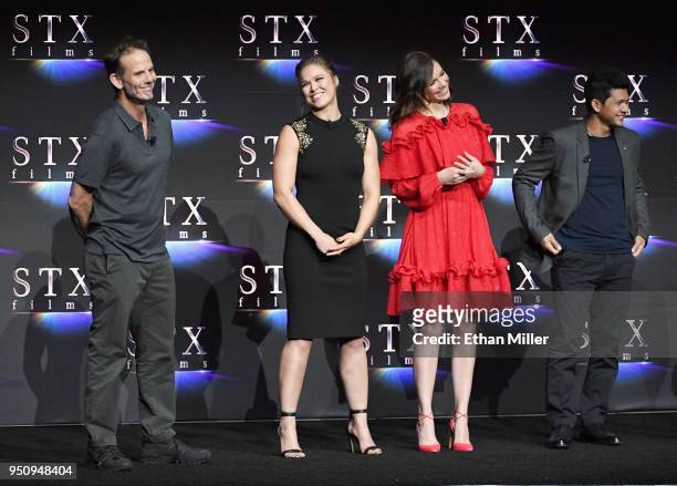 Director Peter Berg and actors Ronda Rousey, Lauren Cohan and Iko Uwais speak onstage during the STXfilms presentation at The Colosseum at Caesars...