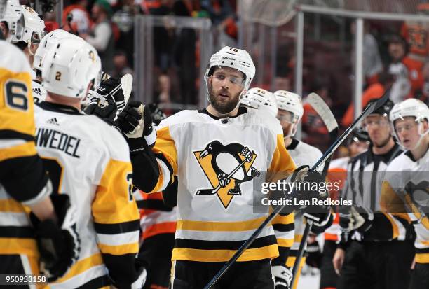 Riley Sheahan of the Pittsburgh Penguins celebrates a third period goal with teammates on the bench against the Philadelphia Flyers in Game Four of...