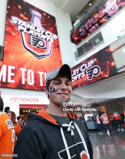 Fan of the Philadelphia Flyers models his painted face on the concourse prior to the start of Game Four of the Eastern Conference First Round during...