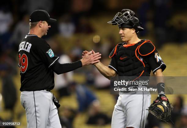 Brad Ziegler and J.T. Realmuto of the Miami Marlins celebrate defeating the Los Angeles Dodgers 3-2 in a game at Dodger Stadium on April 24, 2018 in...