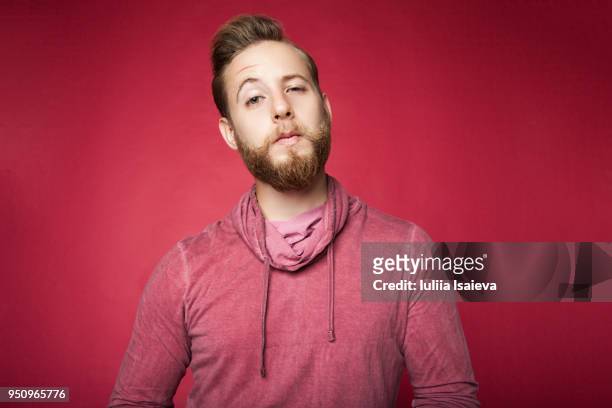 expressive young man looking suspiciously at camera - vanity stock pictures, royalty-free photos & images
