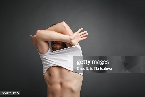Anonymous man taking off t-shirt Anonymous man taking off t-shirt