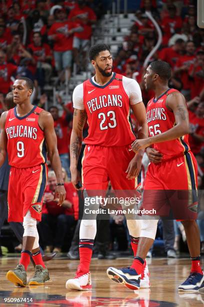 Anthony Davis of the New Orleans Pelicans and E'Twaun Moore of the New Orleans Pelicans walk on the court during the game against the Portland Trail...