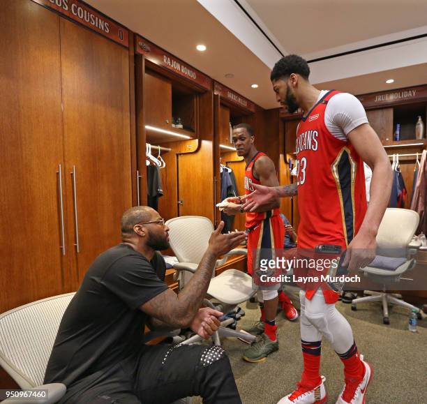Anthony Davis of the New Orleans Pelicans high fives DeMarcus Cousins of the New Orleans Pelicans after the game against the Portland Trail Blazers...