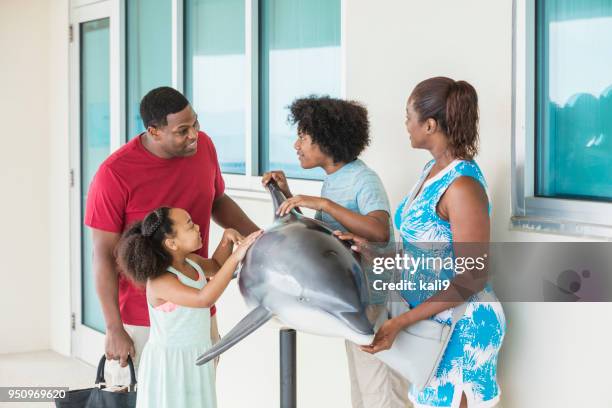 family with two children visiting marine education park - familie zoo stock pictures, royalty-free photos & images