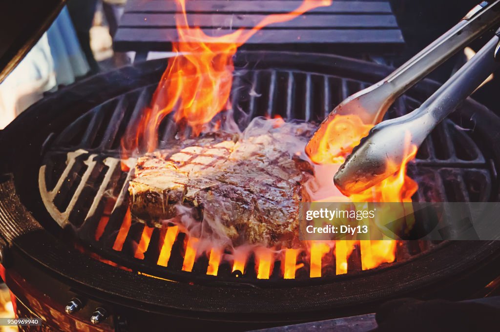 Steak on the grill with flames