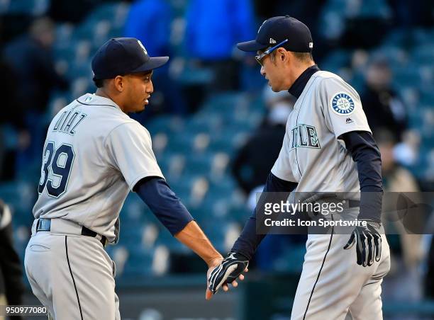 Seattle Mariners relief pitcher Edwin Diaz and Seattle Mariners Ichiro Suzuki shake hands after getting the win against the Chicago White Sox on...