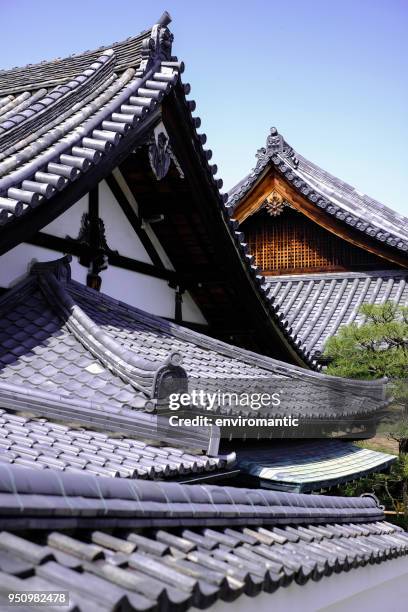 multi-tiered and different directional rooves of shrines in the grounds of the ancient byodo-in temple in kyoto, japan, in springtime. - byodo in temple kyoto stock pictures, royalty-free photos & images