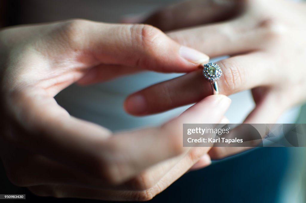A woman wears her engagement ring