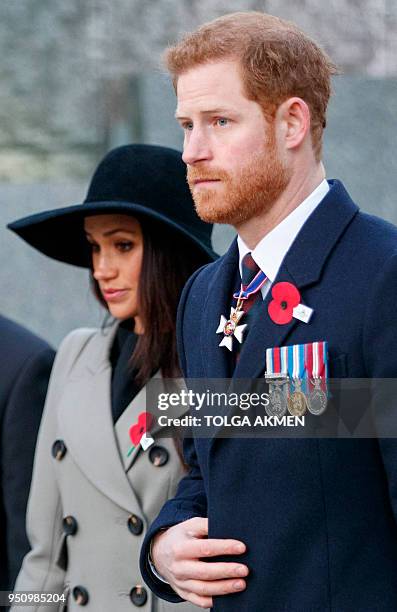 Britain's Prince Harry and his US fiancee Meghan Markle attend an Anzac Day dawn service at Hyde Park Corner in London on April 25, 2018. - Anzac Day...