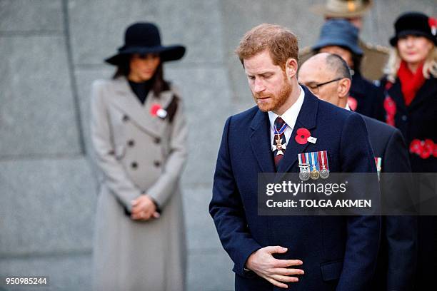 Britain's Prince Harry and his US fiancee Meghan Markle attend an Anzac Day dawn service at Hyde Park Corner in London on April 25, 2018. Anzac Day...