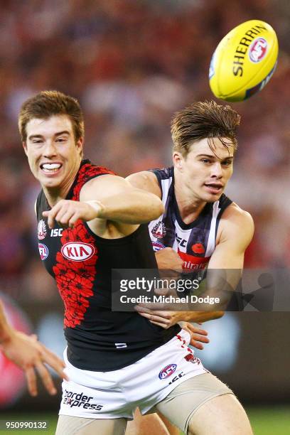 Josh Thomas of the Magpies tackles Zach Merrett of the Bombers during the round five AFL match between the Collingwood Magpies and the Essendon...