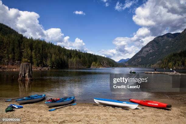 four kayaks at beach in buntzen lake, bc, canada - the blue man group in vancouver stock pictures, royalty-free photos & images