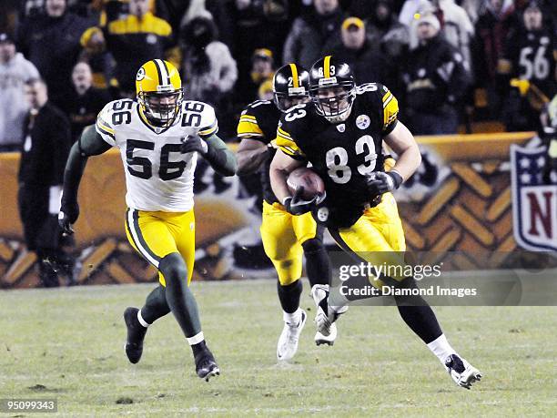 Tight end Heath Miller of the Pittsburgh Steelers carries the ball after catching a pass as linebacker Nick Barnett of the Green Bay Packers...