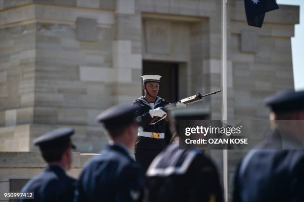 Soldier of the Royal Australian Navy stands to attention during a wreath-laying ceremony at the Lone Pine Memorial on the 103rd anniversary of ANZAC...
