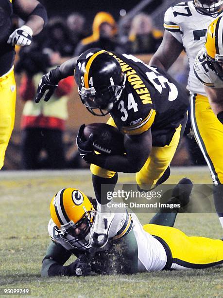 Running back Rashard Mendenhall of the Pittsburgh Steelers is tackled by linebacker Nick Barnett of the Green Bay Packers during a game on December...