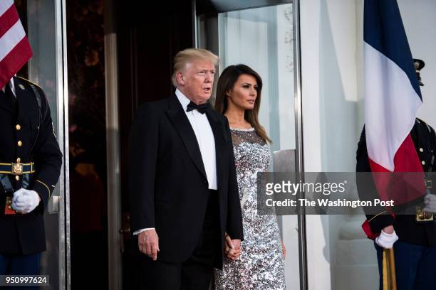 President Donald J. Trump and first lady Melania Trump walk out to the North Portico to greet French President Emmanuel Macron and his wife Brigitte...
