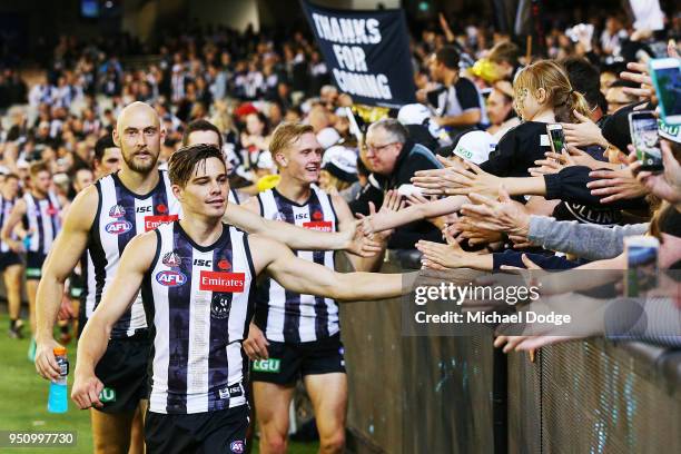 Josh Thomas of the Magpies celebrates the win with fans during the round five AFL match between the Collingwood Magpies and the Essendon Bombers at...