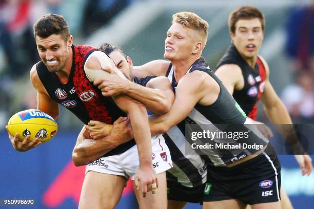 Adam Treloar of the Magpies tackles David Myers of the Bombers during the round five AFL match between the Collingwood Magpies and the Essendon...