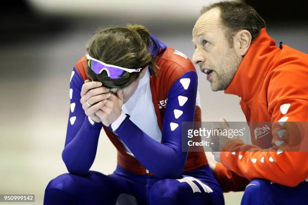 Dutch Coach Gerald Kemkers talks with Dutch skater Ireen Wust after the 1500m event during the World Speed Skating Championship Allround in Thialf,...