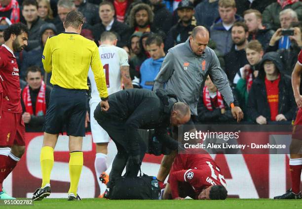 Alex Oxlade-Chamberlain of Liverpool lies injiured during the UEFA Champions League Semi Final First Leg match between Liverpool and A.S. Roma at...