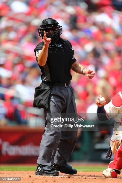 Umpire Chris Guccione class a strike in a game between the St. Louis Cardinals and the Cincinnati Reds at Busch Stadium on April 21, 2018 in St....