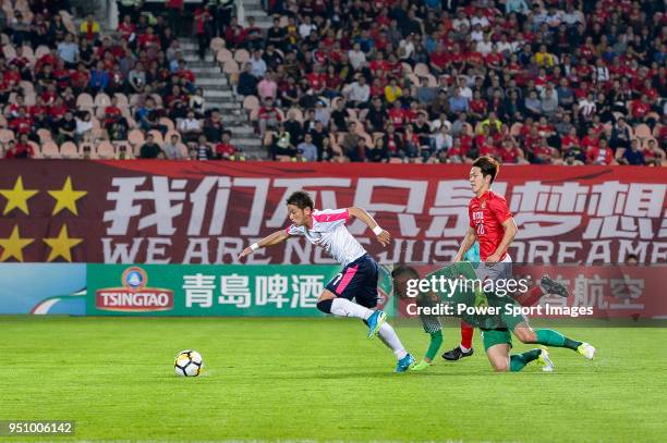 Cerezo Osaka Midfielder Takaki Fukumitsu attempts a kick while being defended by Guangzhou Goalkeeper Zeng Cheng during the AFC Champions League 2018...