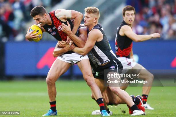 Adam Treloar of the Magpies tackles David Myers of the Bombers during the round five AFL match between the Collingwood Magpies and the Essendon...